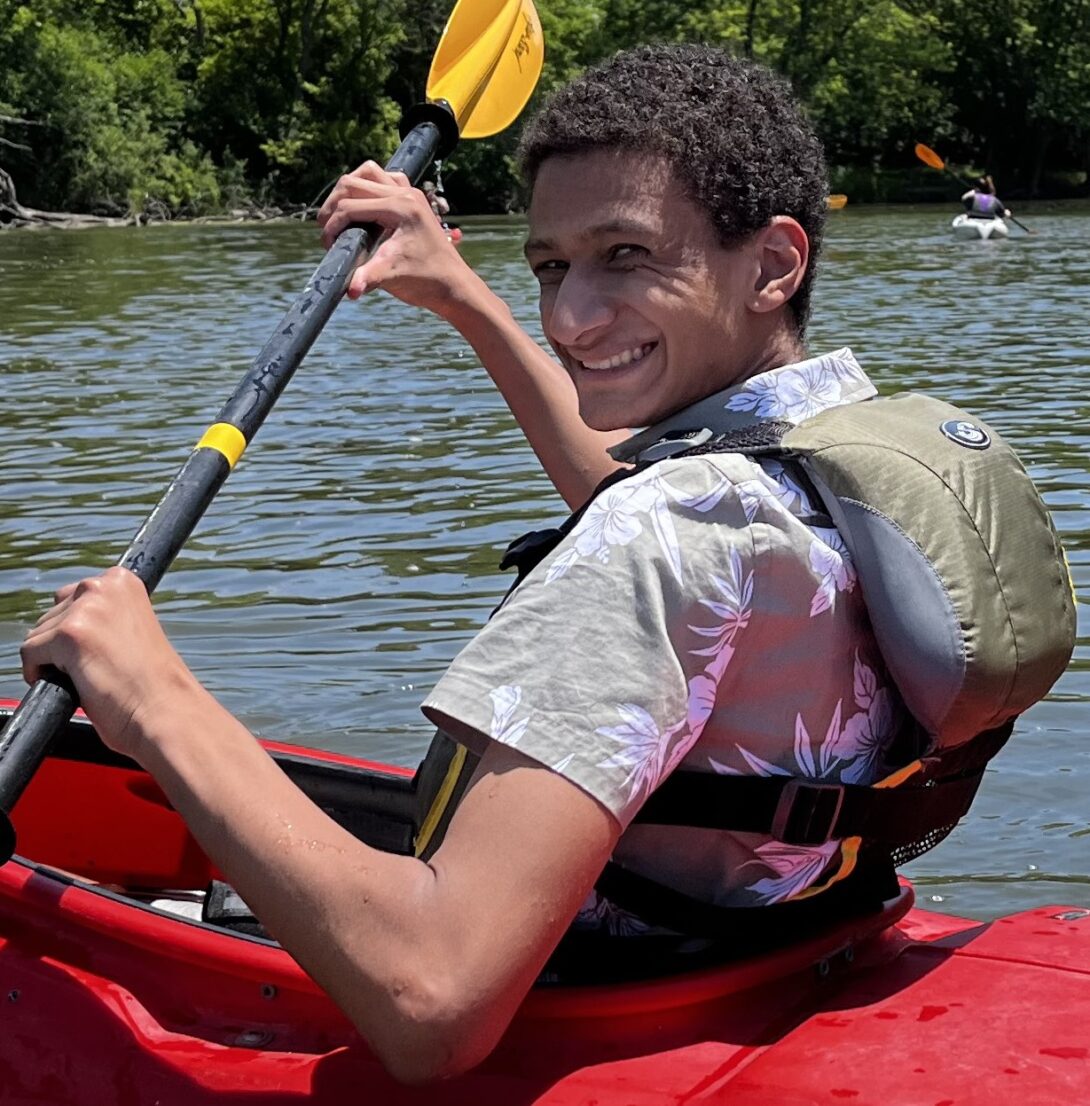Photo of student in kayak holding paddle